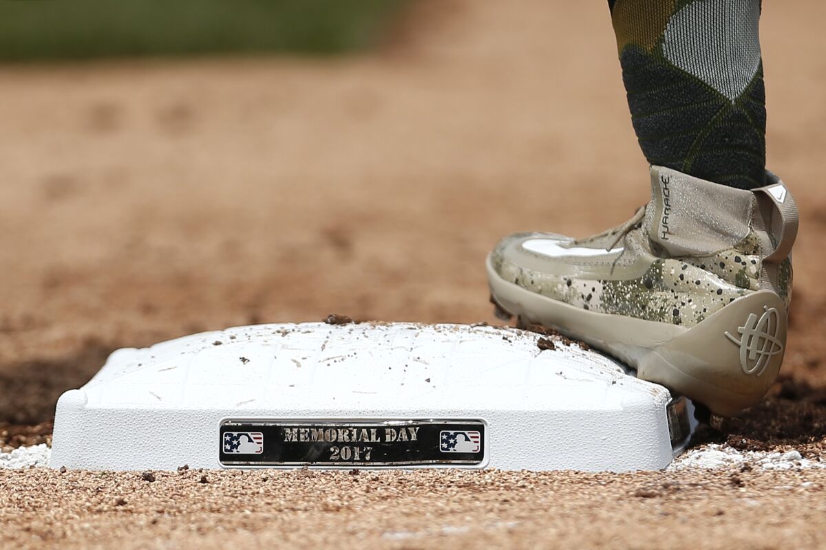 A player stands on first base during a Memorial Day game in 2017.