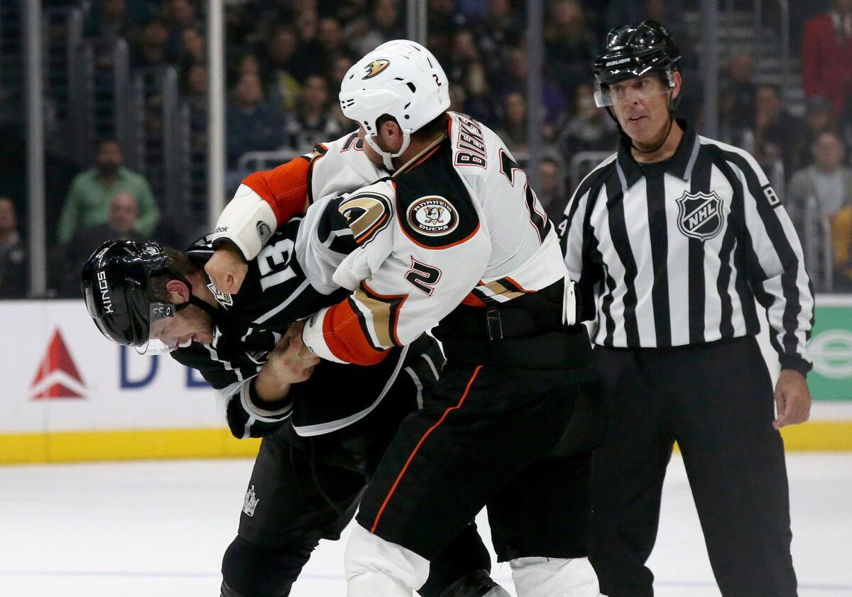 Kings left wing Kyle Clifford fights Ducks defenseman Kevin Bieksa in the first period.