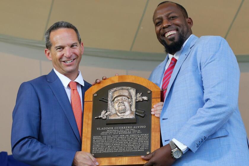COOPERSTOWN, NY - JULY 29: Vladimir Guerrero is presented his plaque from Hall of Fame President Jeff Idelson at Clark Sports Center during the Baseball Hall of Fame induction ceremony on July 29, 2018 in Cooperstown, New York. (Photo by Jim McIsaac/Getty Images) ** OUTS - ELSENT, FPG, CM - OUTS * NM, PH, VA if sourced by CT, LA or MoD **