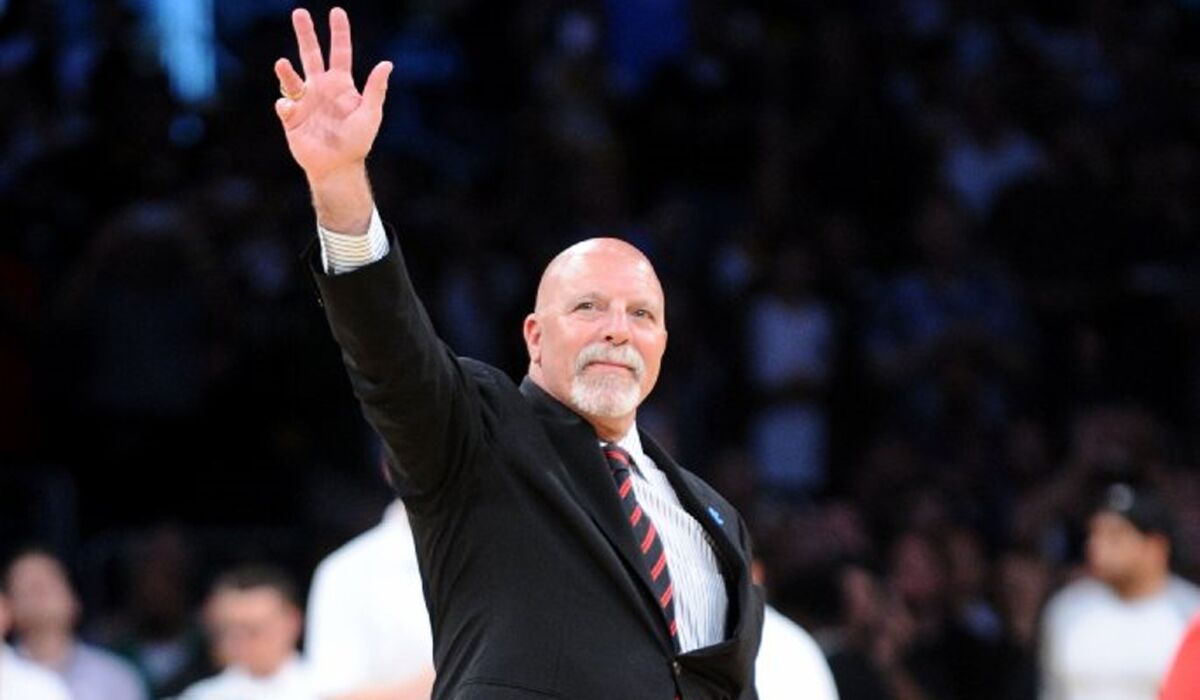 Lakers trainer Gary Vitti waves to the crowd while being honored for his retirement at the end of the season.