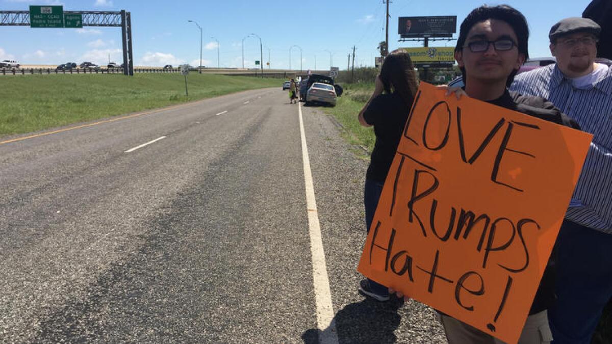 Ben Falcon, 17, born and raised in Corpus Christi, Texas, protests President Trump's arrival in his hometown Tuesday.