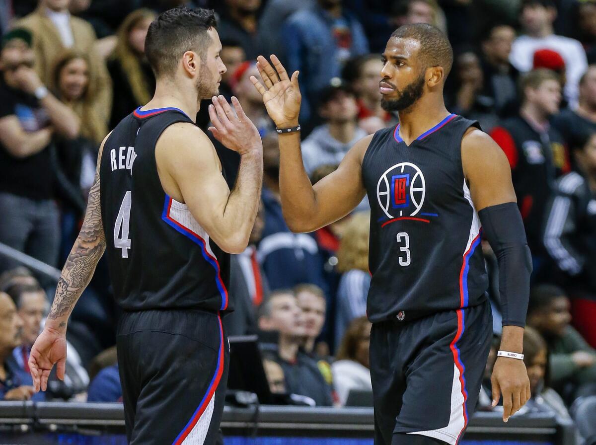 Clippers guard Chris Paul (3) celebrates with teammate J.J. Redick (4) in the closing seconds.