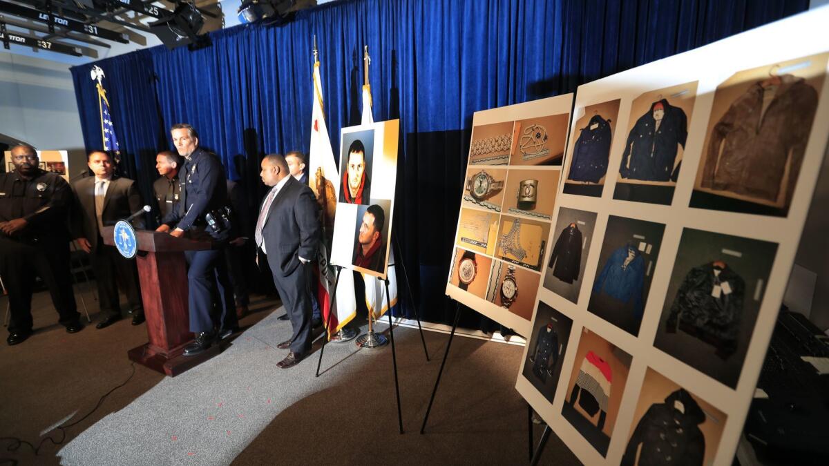 LAPD Capt. Cory Palka, standing at a lectern surrounded by other men, announces an arrest in January.