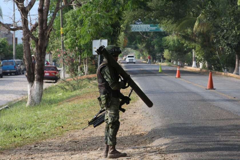 A Mexican soldier stands guard in Villa Purificacion, Jalisco State, Mexico on May 7, 2015.