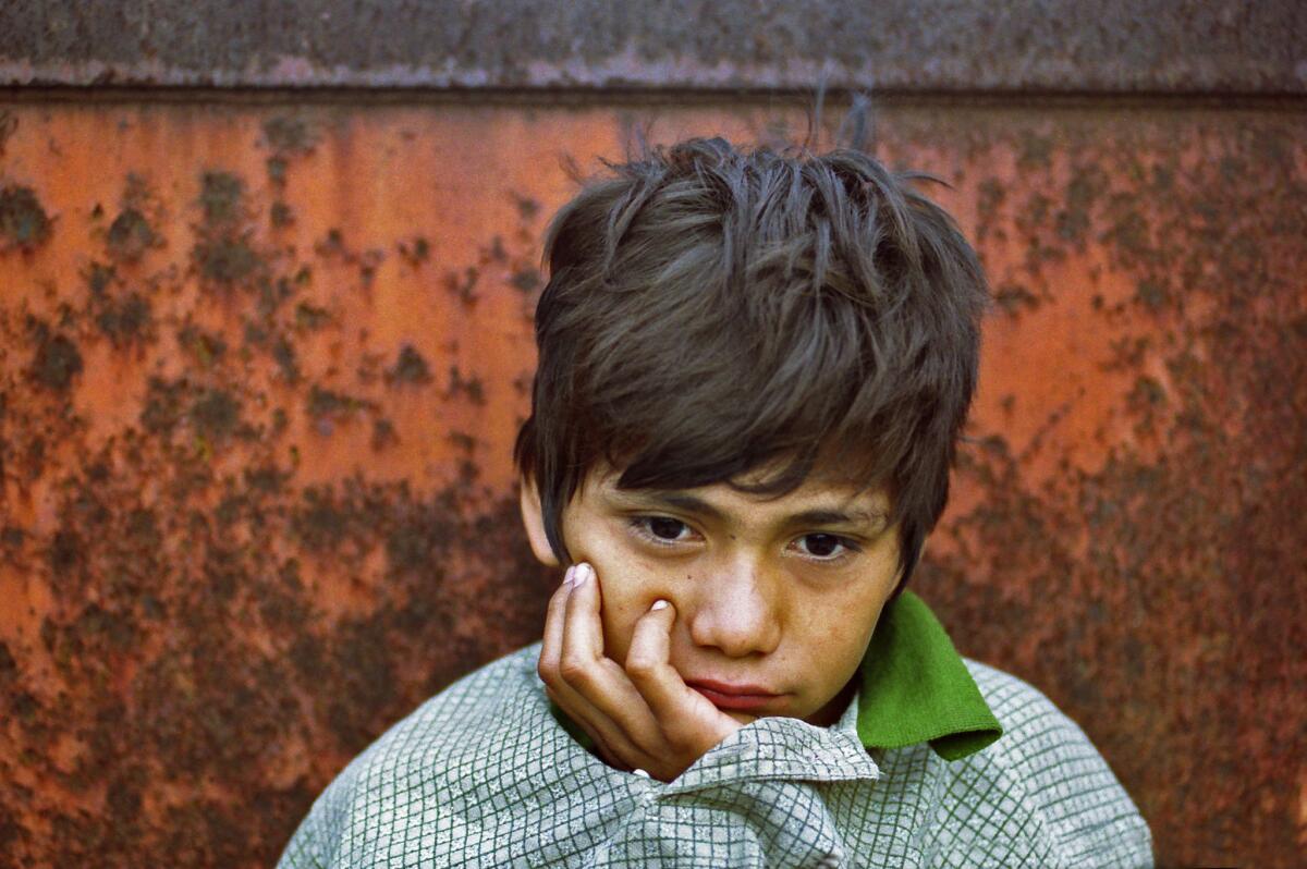 Denis Contreras, at age 12 awakens after sleeping in a gravel-filled hopper car in a Tapachula, Mexico, railroad yard on Aug 1, 2000.
