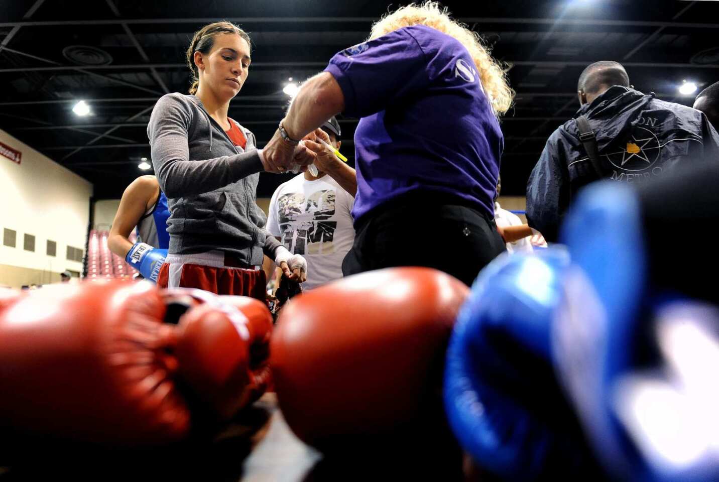 Mikaela Mayer, 21, has her wraps checked before being issued gloves at the Police Athletic League national boxing tournament in Toledo, Ohio, in October.