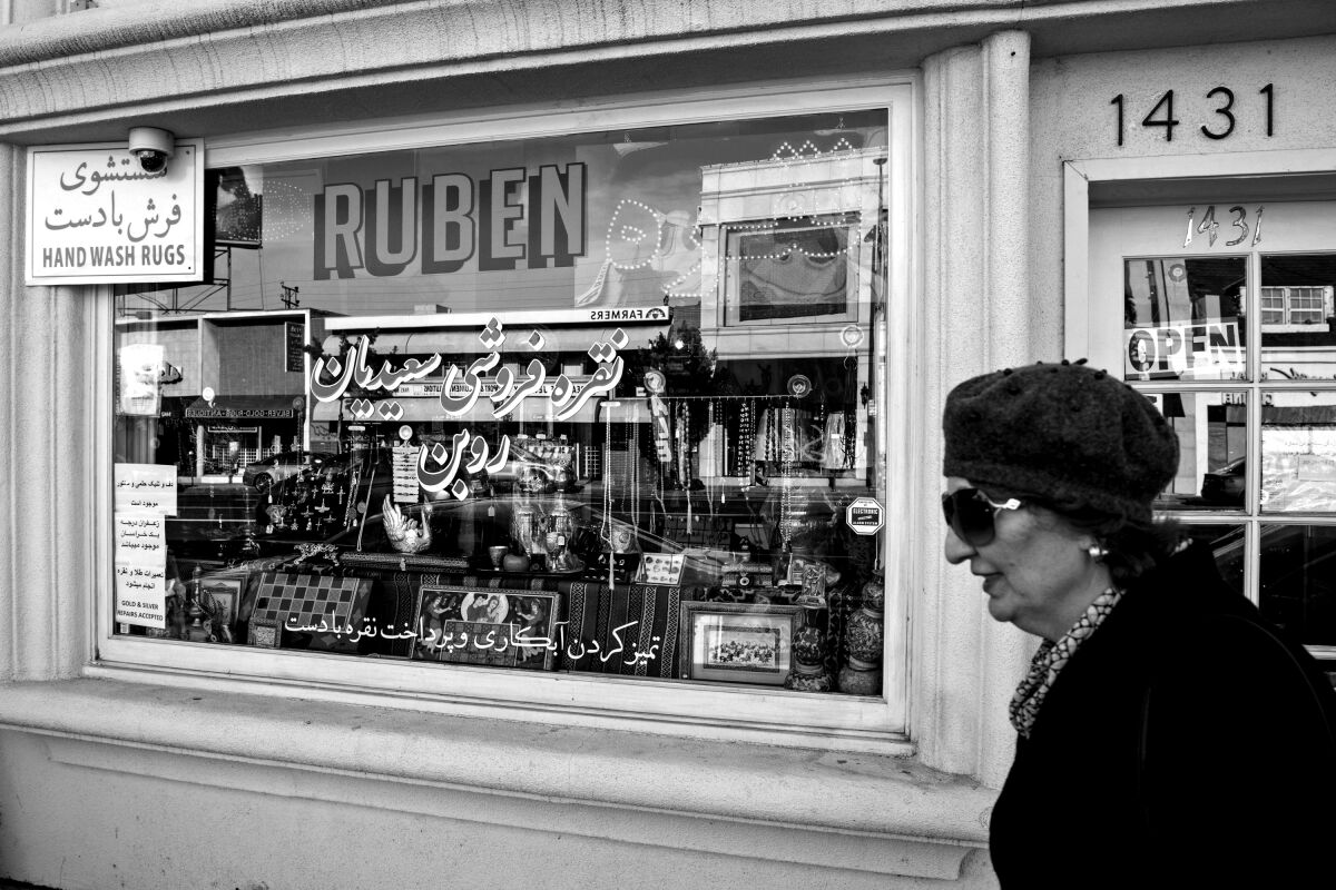 A woman walks by the silver and rug shop Ruben on Westwood Boulevard in Westwood
