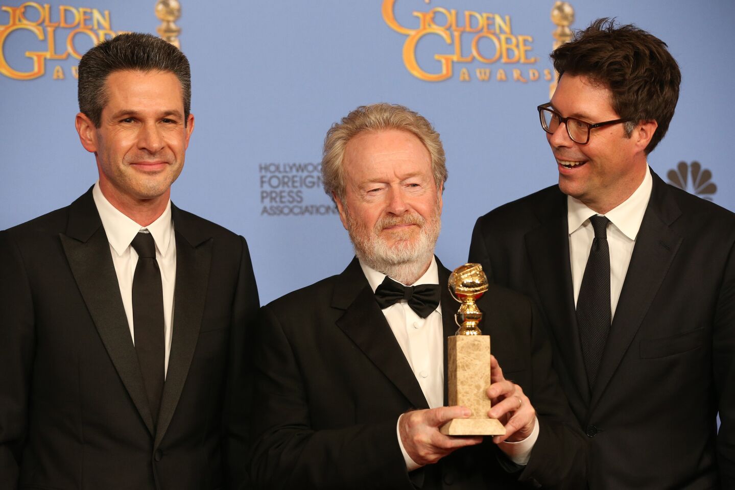 Winners of the best motion picture musical or comedy for "The Martian": Simon Kinberg, left, Ridley Scott and Michael Schaefer.