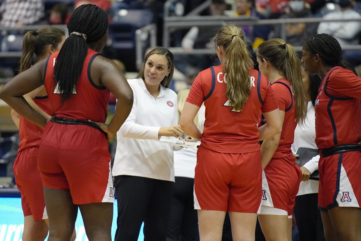 FILE - Arizona head coach Adia Barnes speaks to her team during a time out in the first half of an NCAA college basketball game against Northern Arizona, on Dec. 17, 2021, in Flagstaff, Ariz. Barnes' feathery touch has reconstructed her alma mater from the rubble at the bottom of the Pac-12 to a national powerhouse. (AP Photo/Rick Scuteri)