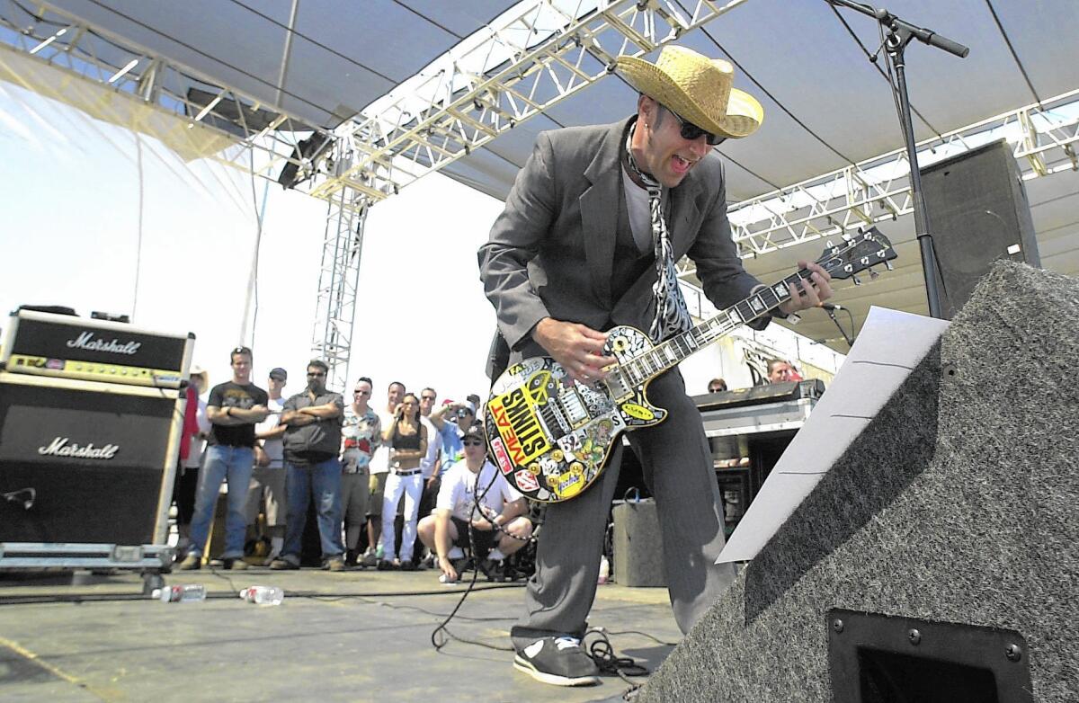 The Cadillac Tramps' Brian Coakley walks the stage while playing the 2001 Hootenanny Festival in Irvine.