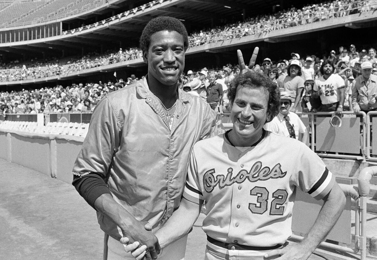 Houston Astros pitcher J.R. Richard shows his sense of humor while shaking hands with Baltimore Orioles pitcher Steve Stone.