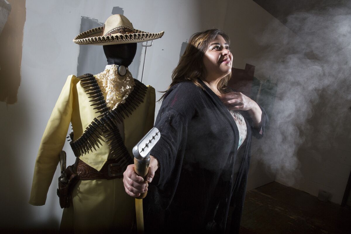 Artist Nao Bustamante will be showing works tied to her project about women and the Mexican Revolution at the Vincent Price Art Museum at East L.A. College. She is seen here with a period-style dress made from Kevlar.