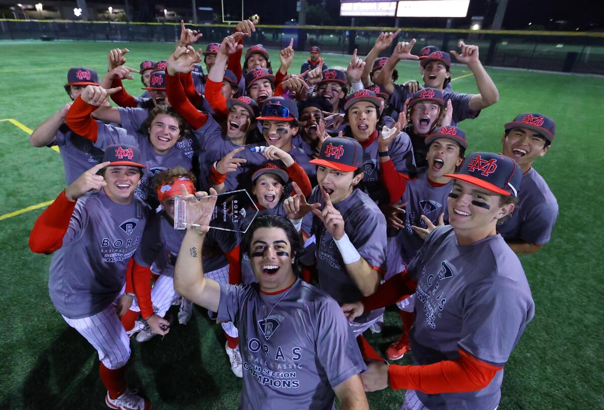 Mater Dei players celebrate after winning the Boras Classic Southern California Division with upset of Corona.