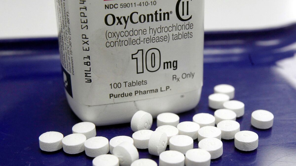 OxyContin pills are counted at a pharmacy in Montpelier, Vt.