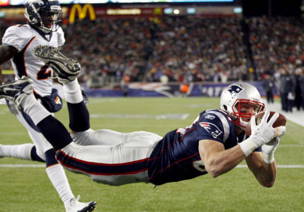 New England Patriots tight end Rob Gronkowski (87) catches a 10-yard touchdown pass against the Denver Broncos in 2012. He underwent successful back surgery Tuesday.