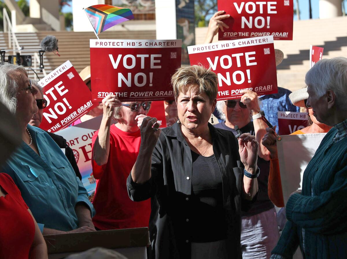 Former mayor Barbara Delgleize makes comments surrounded by supporters during the rally at city hall on Wednesday.