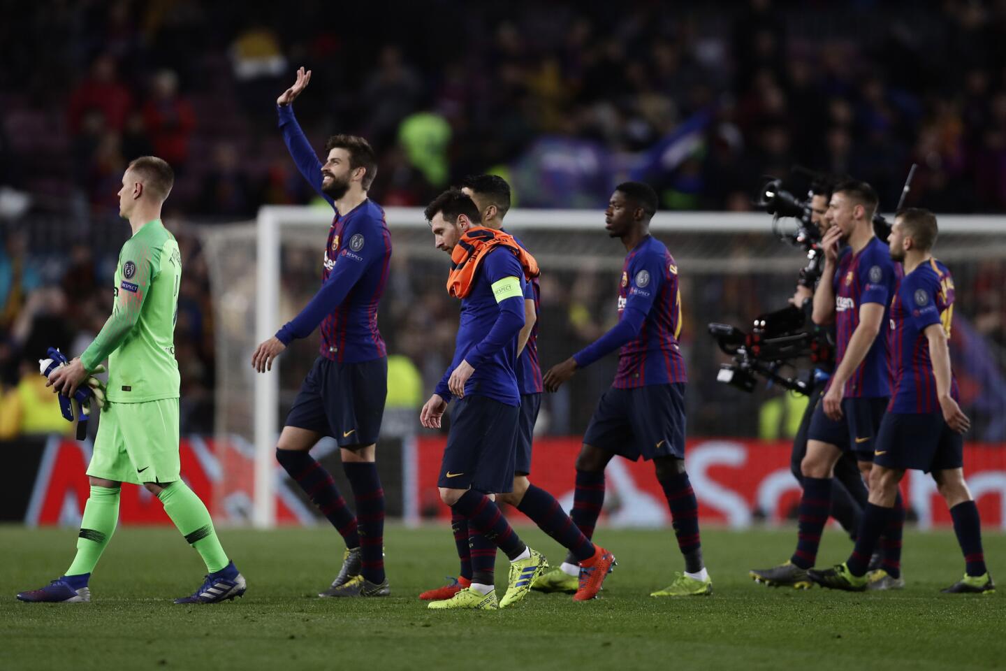 Barcelona defender Gerard Pique, second left, applauds fans at the end of the Champions League round of 16, 2nd leg, soccer match between FC Barcelona and Olympique Lyon at the Camp Nou stadium in Barcelona, Spain, Wednesday, March 13, 2019. (AP Photo/Manu Fernandez)