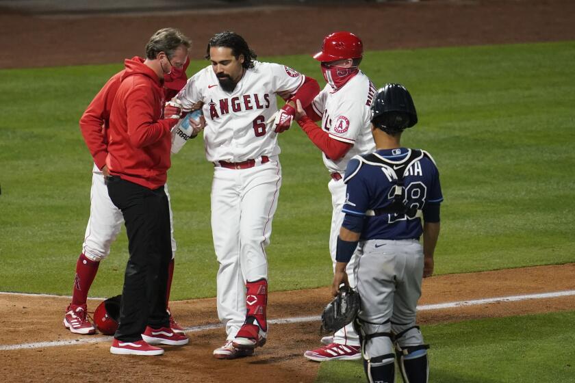 The Angels' Anthony Rendon (6) is helped up after hitting a foul ball off his leg during the eighth inning May 3, 2021.