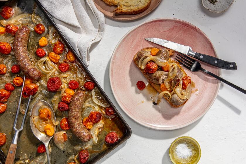 LOS ANGELES, CALIFORNIA, March 5, 2021: Sheet Pan Sausages with Cherry Tomatoes and Onions on toast for the Week-of-Meals story by Ben Mims, photographed on Wednesday, June 2, 2021, at Proplink Studios in Arts District Los Angeles. (Photo and Prop Styling / Silvia Razgova, Prop Styling / Sean Bradley, Food styling / Ben Mims) ATTN: 783117-fo-june-week-of-meals