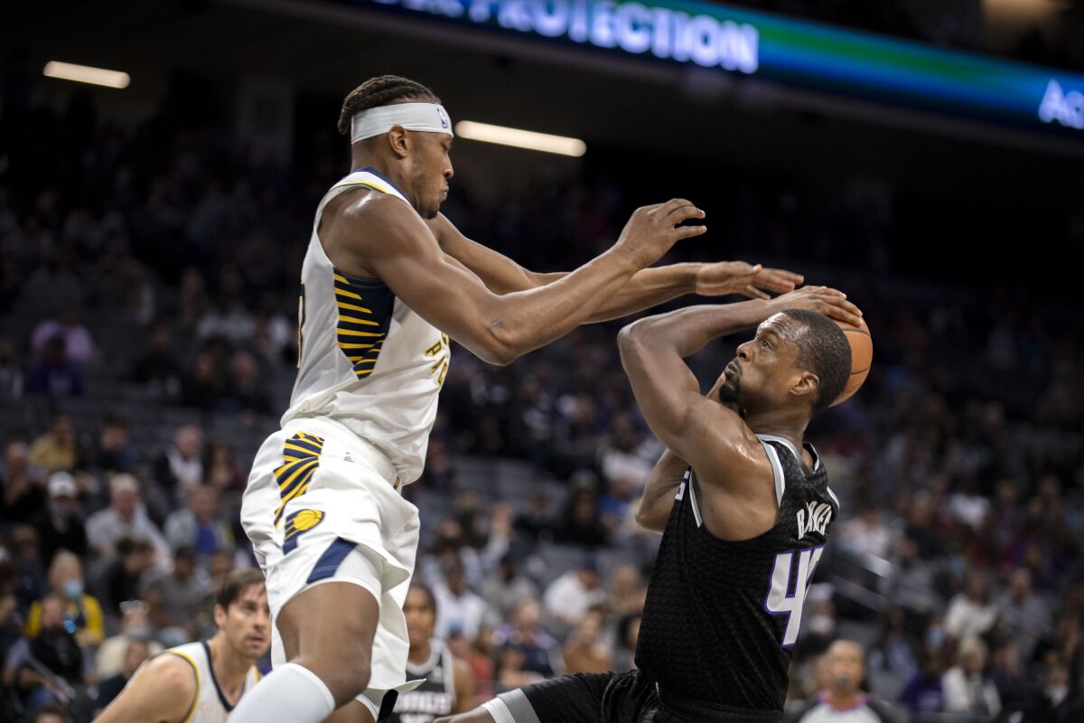 Indiana Pacers center Myles Turner, front left, defends against Sacramento Kings forward Harrison Barnes (40) during the first half of an NBA basketball game in Sacramento, Calif., Sunday, Nov. 7, 2021. (AP Photo/José Luis Villegas)