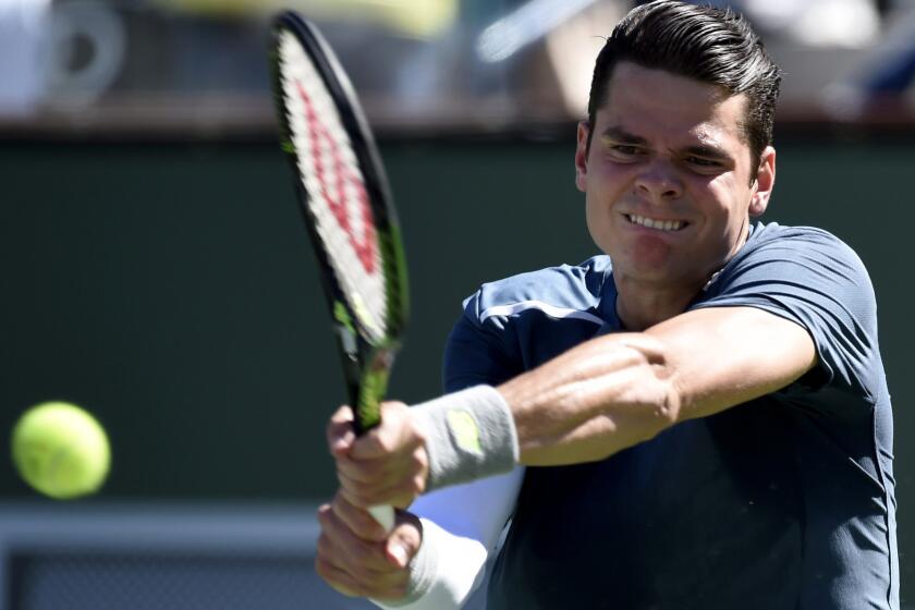Milos Raonic swats a backhand during his three-set victory over Rafael Nadal on Friday at the Paribas Open.