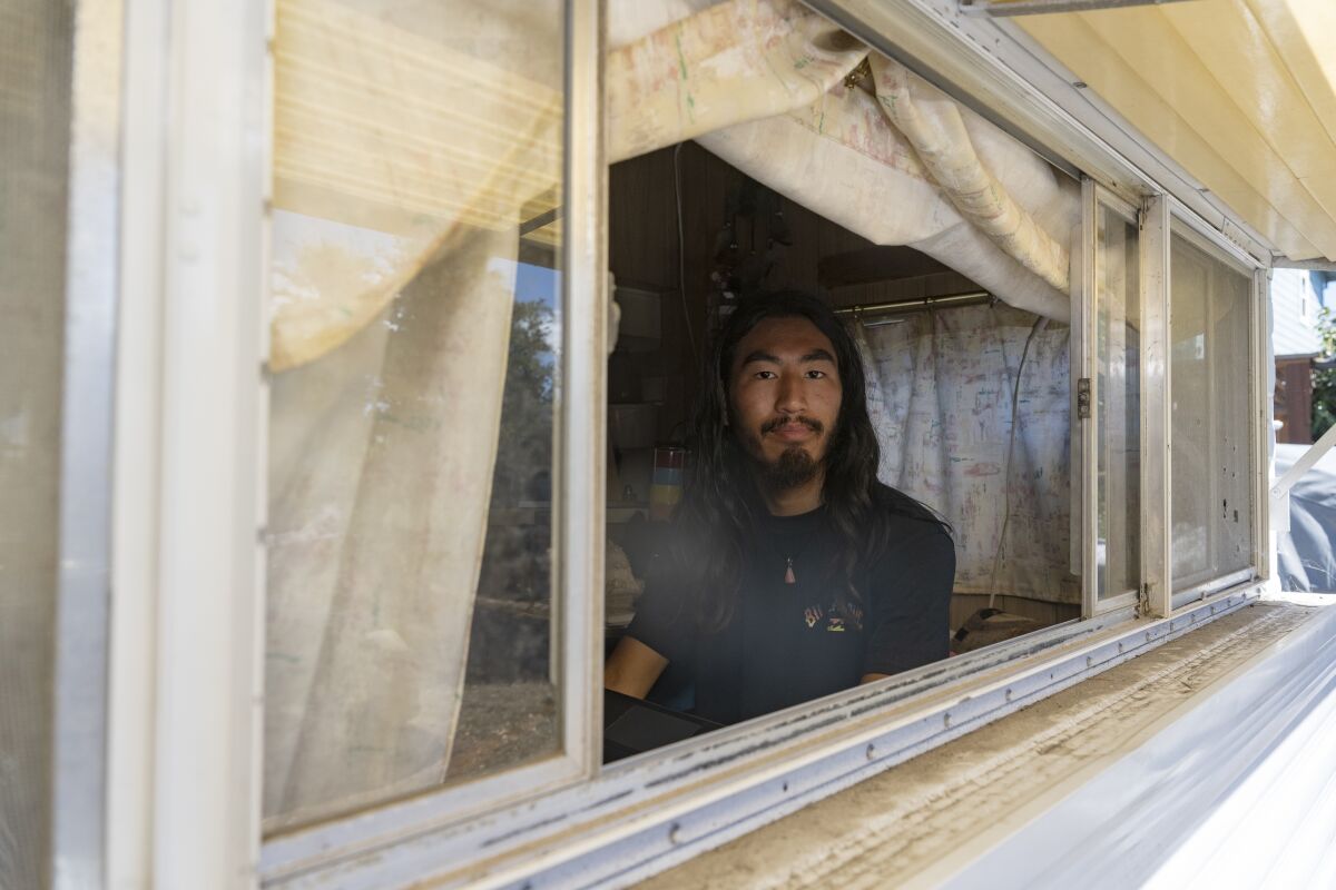 A man inside a trailer where he lives.