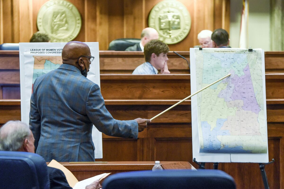 FILE - Sen. Rodger Smitherman compares U.S. Representative district maps during the special session on redistricting at the Alabama Statehouse in Montgomery, Ala., on Nov. 3, 2021. The Supreme Court has put on hold a lower court ruling that Alabama must draw new congressional districts before the 2022 elections, boosting Republican chances to hold six of the state’s seven seats in the House of Representatives. (Mickey Welsh/The Montgomery Advertiser via AP, File)