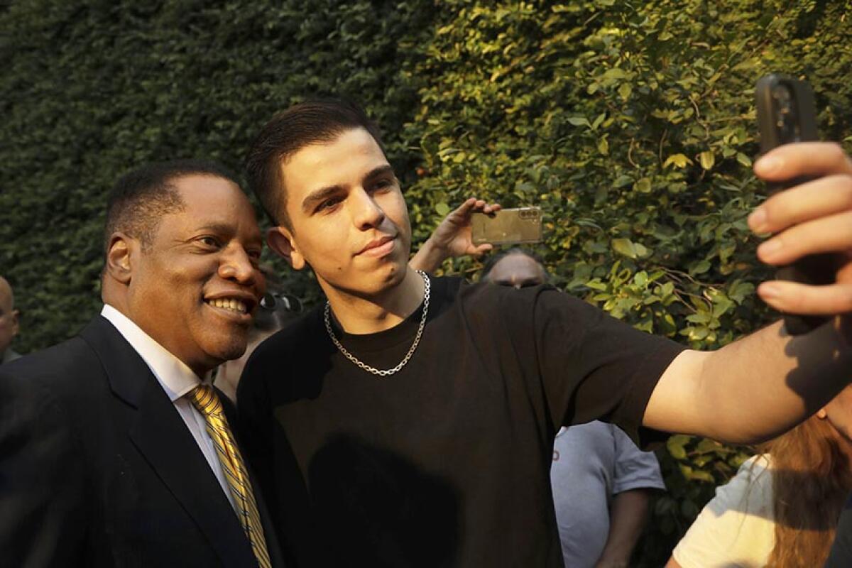 Larry Elder, left, with a supporter.