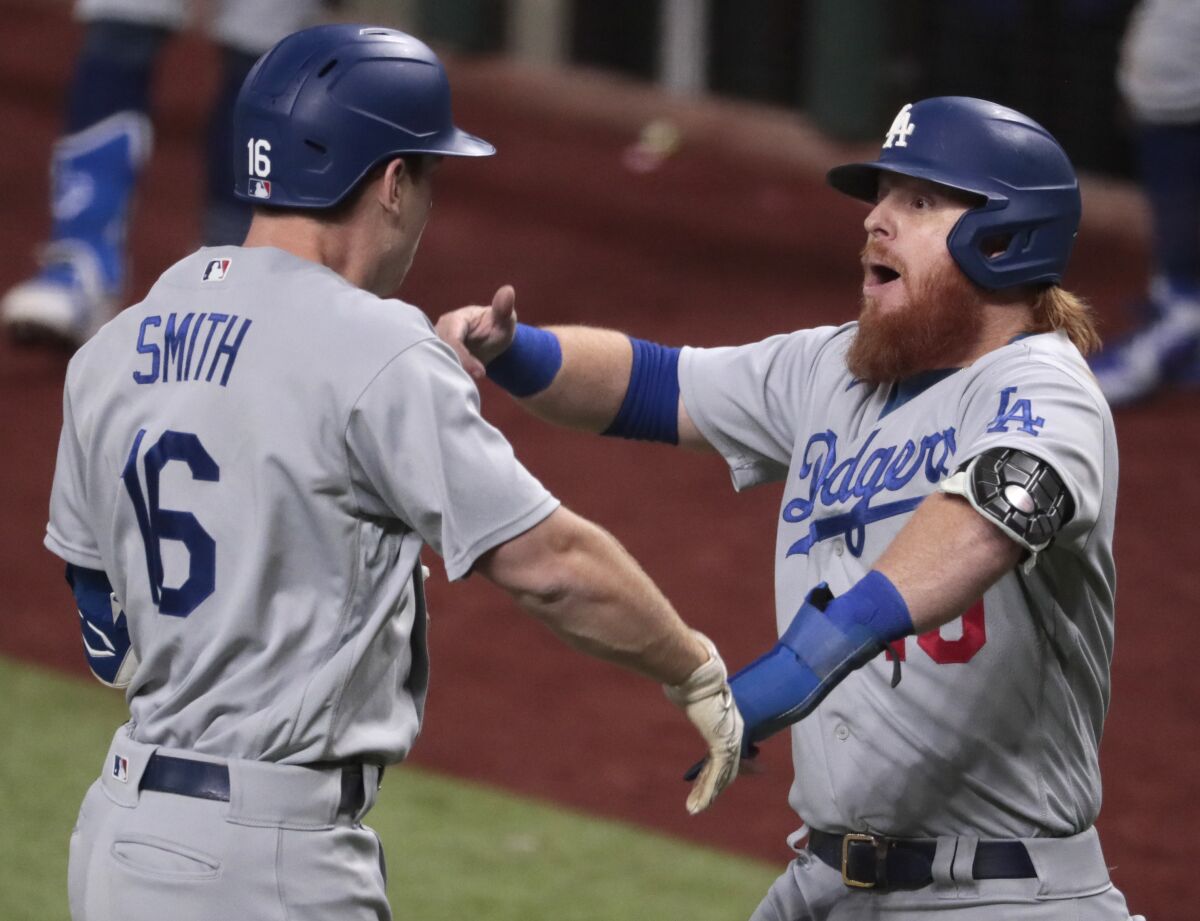 Will Smith and Justin Turner celebrate after Smith hit a three-run homer in Game 5 of the 2020 NLCS