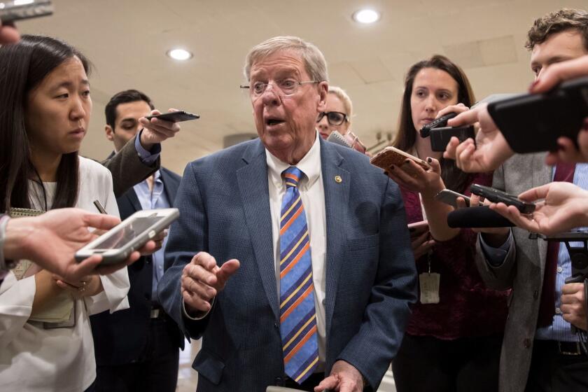 Sen. Johnny Isakson, R-Ga., a member of the tax-writing Senate Finance Committee, takes questions from reporters as he and other lawmakers head to the Senate floor for votes on Capitol Hill in Washington, Monday evening, Nov. 27, 2017. President Donald Trump and Senate Republicans are scrambling to change a Republican tax bill in an effort to win over holdout GOP senators and pass a tax package by the end of the year. (AP Photo/J. Scott Applewhite)
