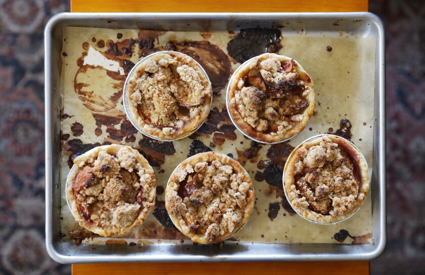 A baking sheet with five small pies