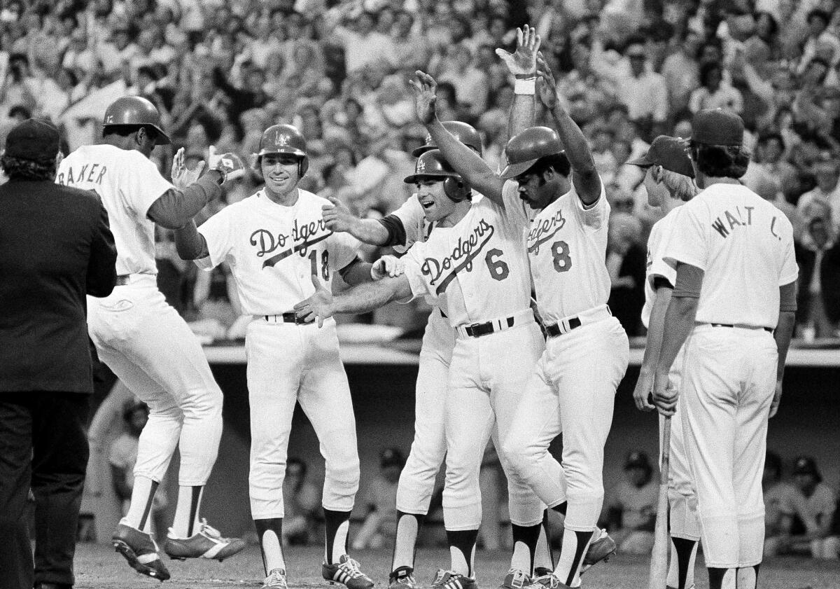 Dusty Baker is greeted by, from left, Bill Russell, Rick Monday, Steve Garvey and Reggie Smith, after hitting a grand slam.