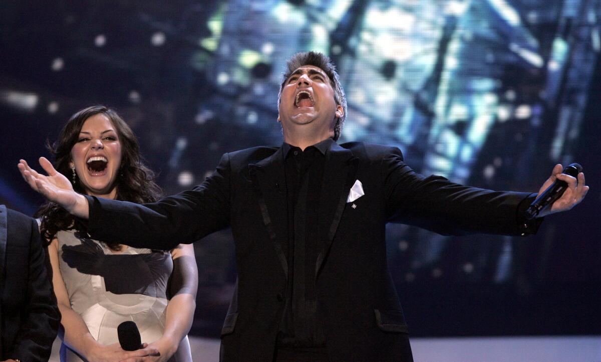Taylor Hicks reacts after being announced the winner of season five of American Idol on Wednesday, May 24, 2006 in Los Angeles. In the background is runner up Katharine McPhee. (AP Photo/Kevork Djansezian)