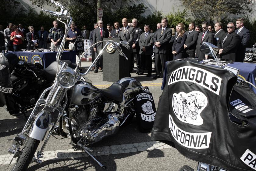 Los Angeles County Sheriff Lee Baca, at podium, speaks during a news conference Tuesday, Oct. 21, 2008, in Los Angeles. Dozens of burly, tattoo-covered Mongol motorcycle gang members were arrested Tuesday by federal agents in six states, including Washington, on warrants ranging from drug sales to murder after a three-year undercover investigation in which four agents successfully infiltrated the group. (AP Photo/Ric Francis)