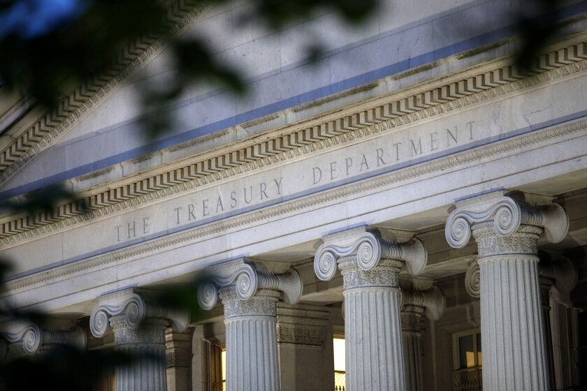 FILIE - This June 6, 2019, file photo shows the U.S. Treasury Department building at dusk in Washington. On Monday, May 3, 2021, the Treasury Department said it expects to borrow $463 billion in the current April-June quarter and $2.28 trillion for the full budget year, as the government finances continued pandemic relief measures. (AP Photo/Patrick Semansky, File)