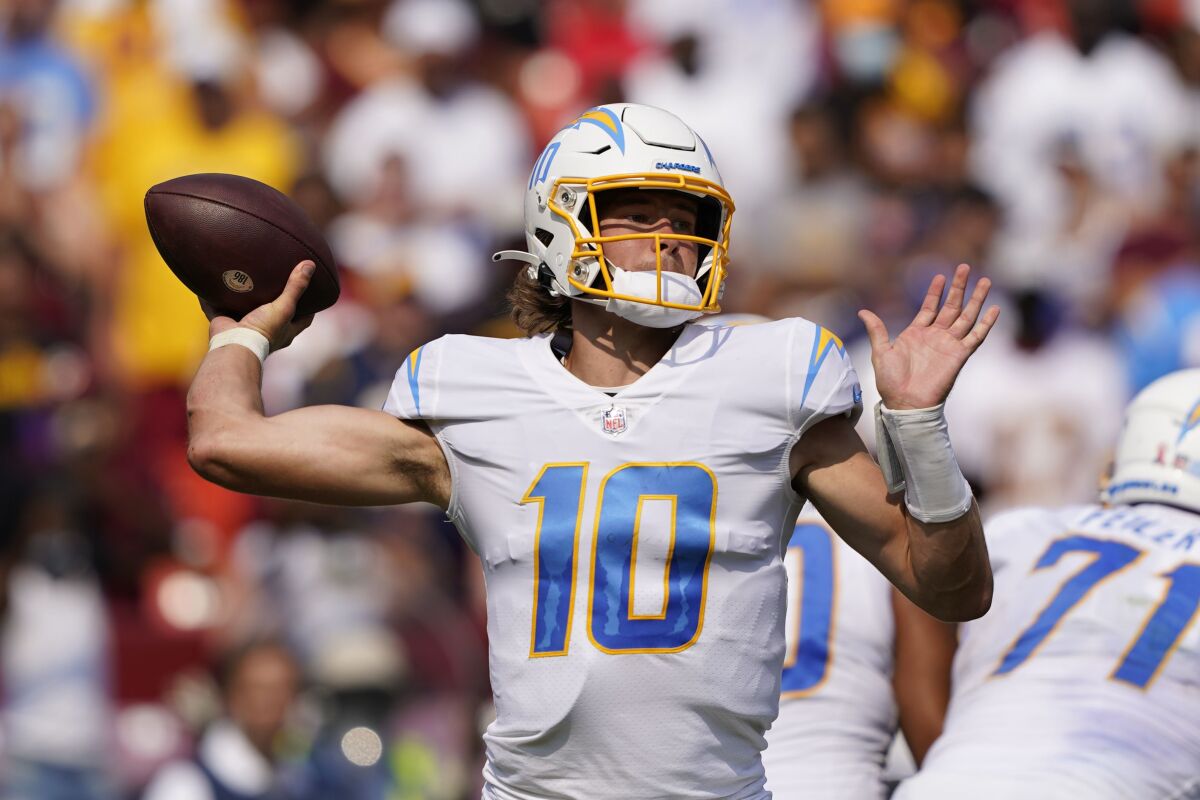 Los Angeles Chargers quarterback Justin Herbert (10) throws the ball during the second half of an NFL football game, Sunday, Sept. 12, 2021, in Landover, Md. Herbert threw for 337 yards to beat Washington 20-16. (AP Photo/Andrew Harnik)