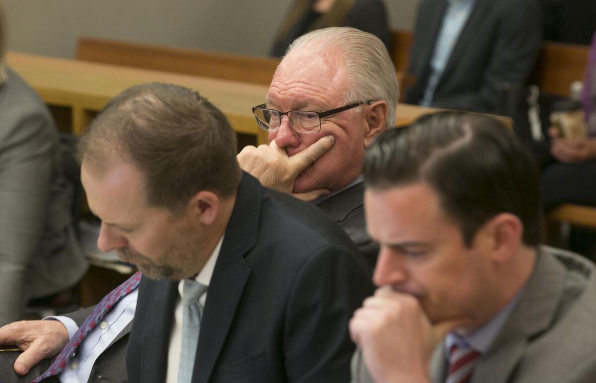 Plaintiff's attorney Ed Chapin, rear, and fellow attorneys, Brian Holm, left front, and John O'Brien, right, in court