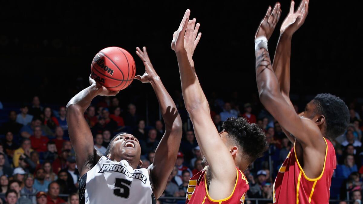 Providence's Rodney Bullock is forced into a tough shot by USC defenders during the first half.