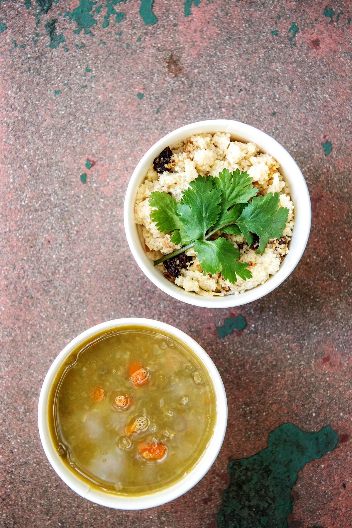 Couscous with fruit and nuts alongside a bowl of lentil and fennel soup.