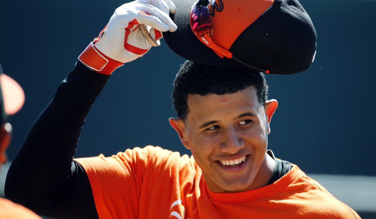 Orioles third baseman Manny Machado prepares to step into the batting cage during a spring training workout.