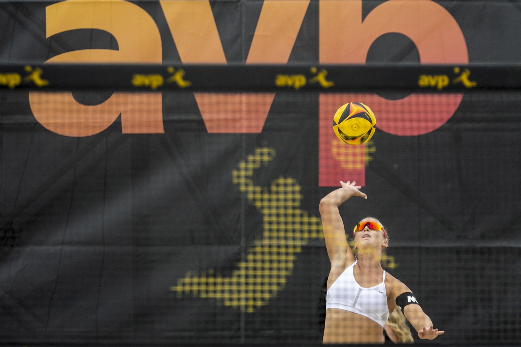 A volleyball player serves at the finals at the AVP Hermosa Beach Open.
