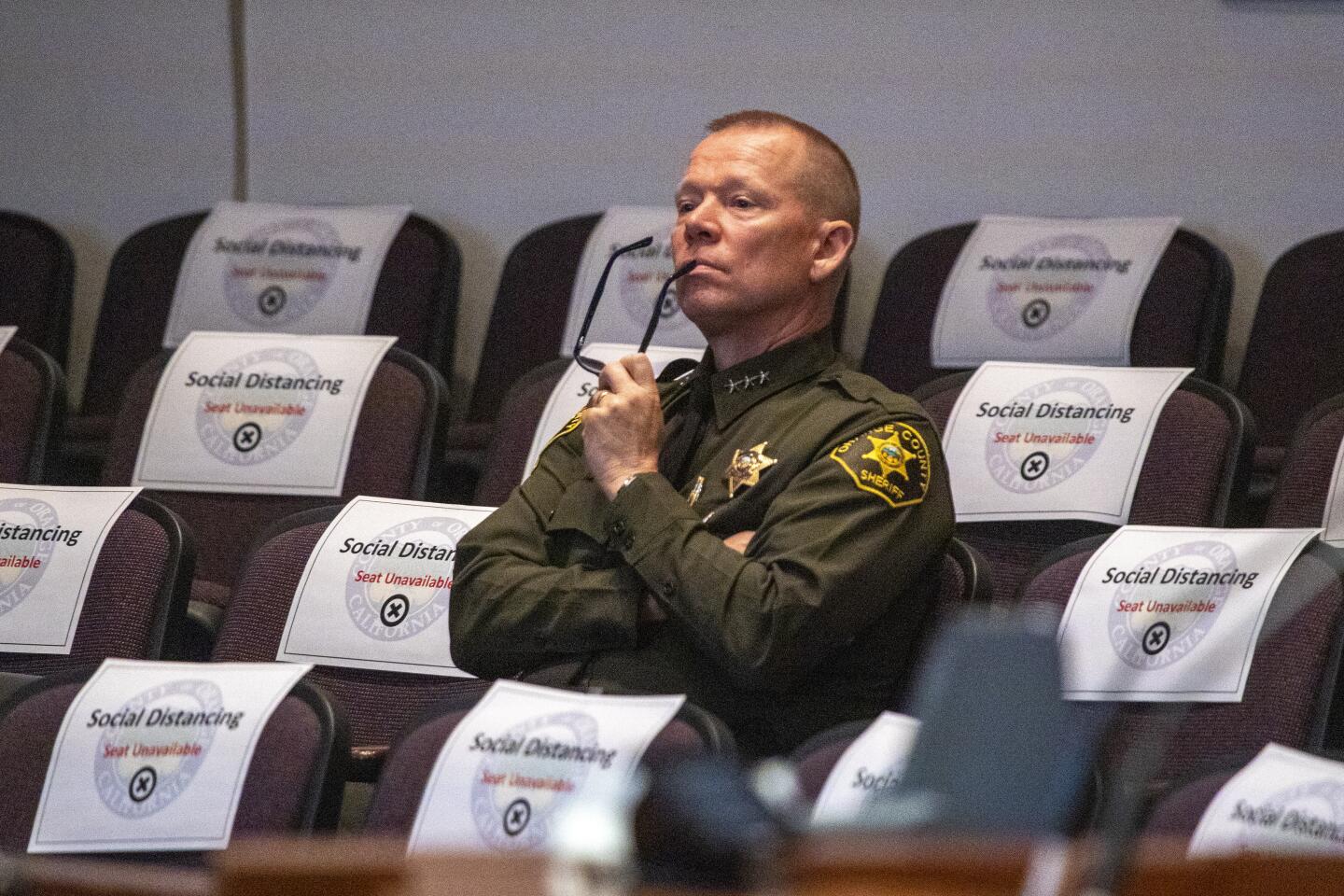 Orange County Undersheriff Bob Peterson listens during a board of supervisors discussion on combating the coronavirus in Santa Ana.
