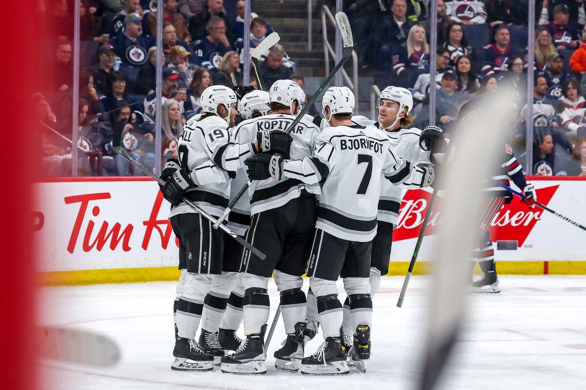Kings players, including Anze Kopitar, celebrate a first-period goal in Winnipeg, Canada.