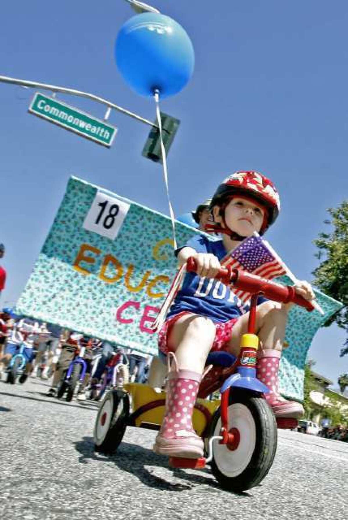Annika Kulawika, 2, rides her bike in the 2011 Fiesta Days Memorial Day Parade on Foothill Boulevard in La Canada Flintridge.