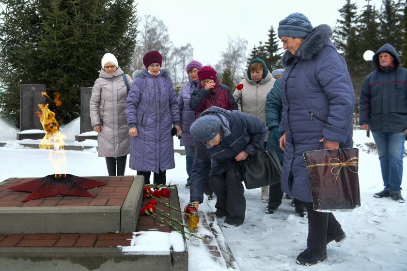 Women lay flowers in memory of those who were killed in the plane on Wednesday, at the memorial to soldiers who died in the Great Patriotic War "Enternal Flame" in Belgorod, Russia, Thursday, Jan. 25, 2024. A Russian military transport plane crashed in a border region near Ukraine. Moscow accused Kyiv of shooting it down and said that all 74 people aboard were killed on Wednesday. Russia said the fatalities included 65 Ukrainian POWs. (AP Photo)