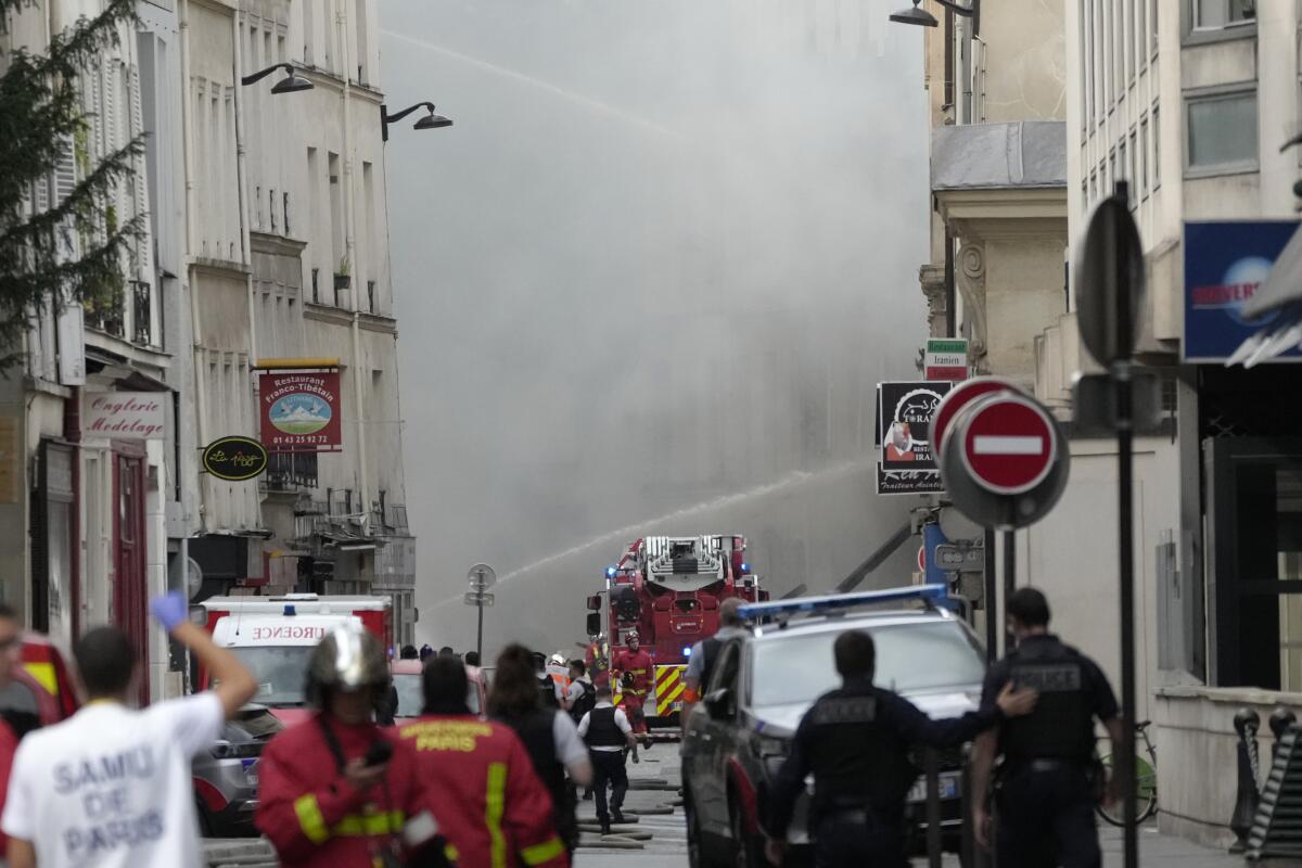 Firefighters use a water canon as they battle a blaze in Paris. 