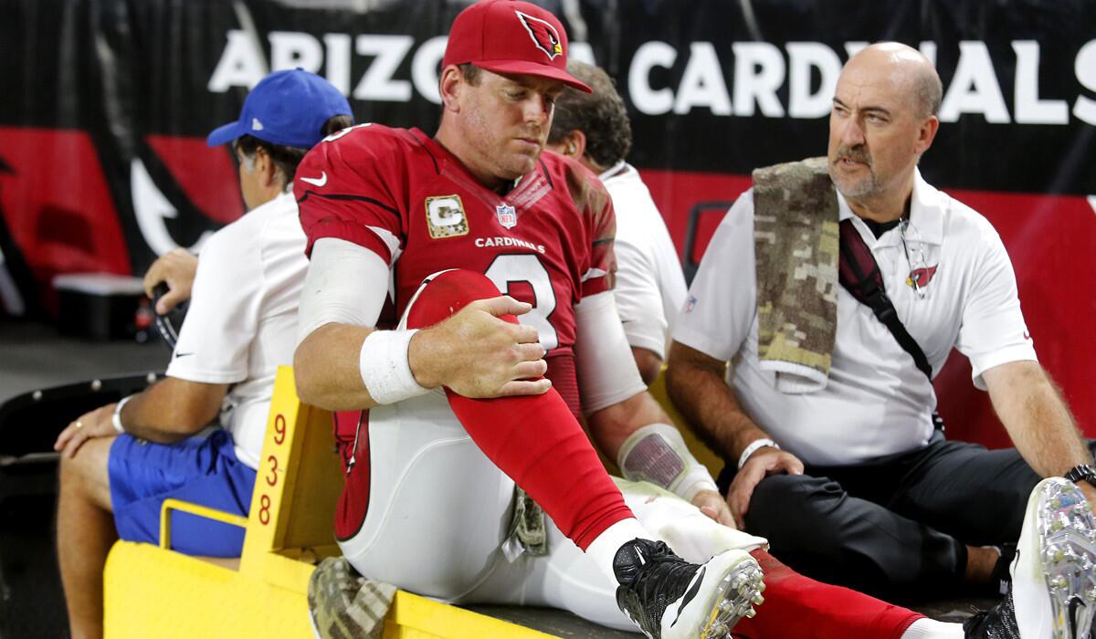 Arizona Cardinals quarterback Carson Palmer (3) is carted to the locker room after injuring his left knee against the St. Louis Rams on Sunday.