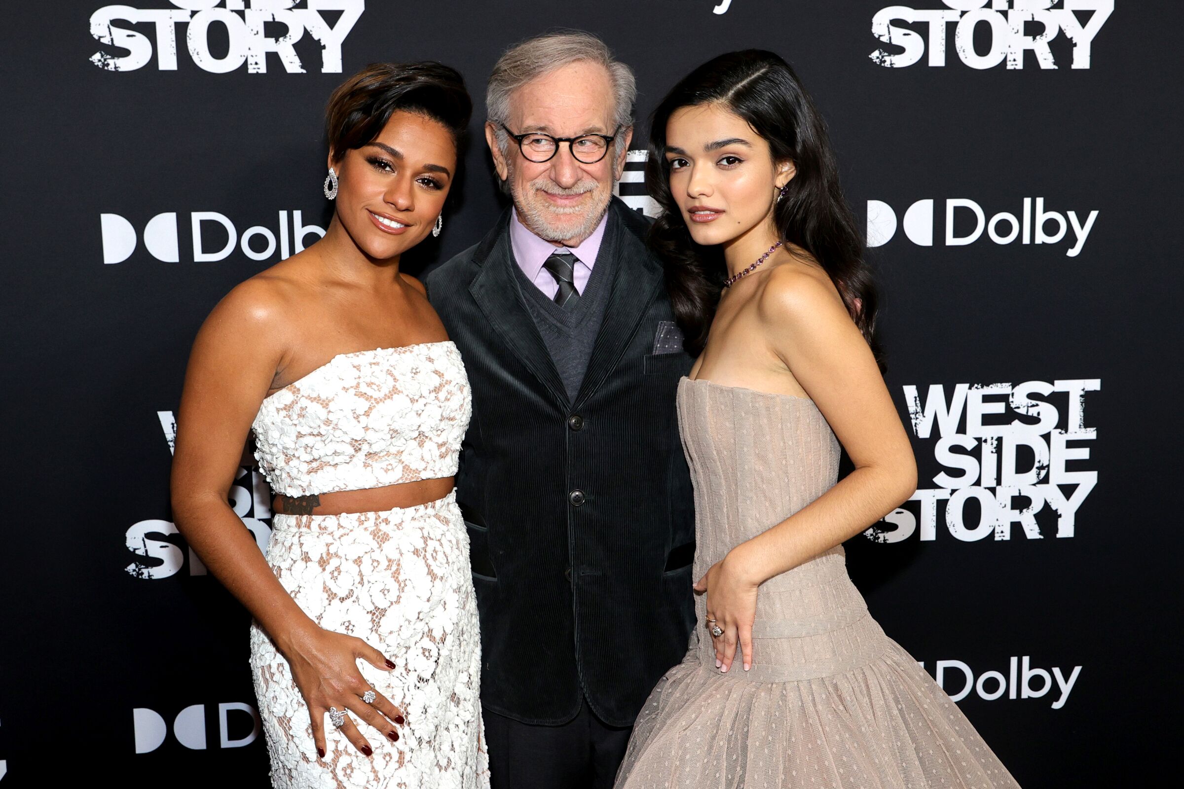A man is flanked by two women in evening gowns at the New York premiere of "West Side Story."