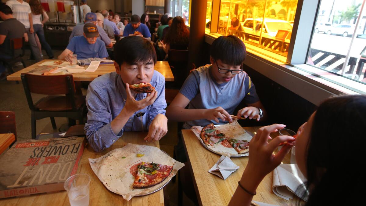 The Lee family digs in at Blaze Pizza's Pasadena location.