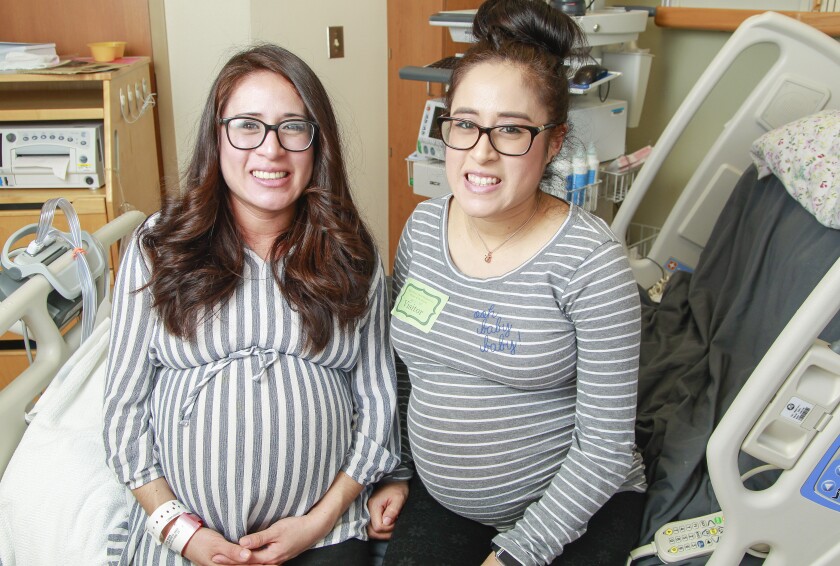 Twins Jazmin Vazquez (left) and Eve Roman, shown last Tuesday at the Sharp Mary Birch Hospital for Women & Newborns. Two days later, Vazquez gave birth to triplet boys.